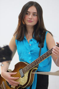 Penny playing her guitar